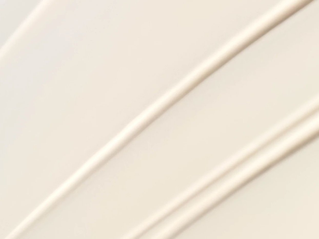 Man with Cle de Peau skincare product